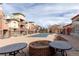 Inviting community pool area featuring tables, fire pit, and well-maintained landscaping for relaxation at 4100 Albion St # 205, Denver, CO 80216