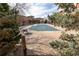 Outdoor community pool partially closed for the season, surrounded by trees, tables and beautiful landscaping at 4100 Albion St # 205, Denver, CO 80216