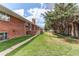 View of the house from the lawn including patio, yard, garden and brick exterior at 2081 W Ridge Rd, Littleton, CO 80120