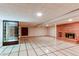 Finished basement offering tiled floors, a brick fireplace, and a lit-up display case at 2081 W Ridge Rd, Littleton, CO 80120