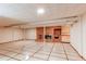 Finished basement featuring tiled floors, a brick fireplace, and overhead lighting at 2081 W Ridge Rd, Littleton, CO 80120