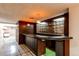 Finished basement with bar area featuring pendant lights, shelving, and ample counter space at 2081 W Ridge Rd, Littleton, CO 80120
