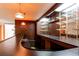 Finished basement bar area with hanging lights and lots of shelving and counterspace at 2081 W Ridge Rd, Littleton, CO 80120