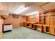 Basement with pegboard walls, cabinets, and a durable green linoleum floor at 2081 W Ridge Rd, Littleton, CO 80120