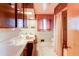 Bright bathroom features dual sinks, tiled shower with curtain, and cabinet storage at 2081 W Ridge Rd, Littleton, CO 80120