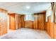 Bedroom featuring wood paneling, carpeted floors, and natural light from windows at 2081 W Ridge Rd, Littleton, CO 80120