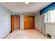 Bedroom features neutral carpet, closet, and window with valances at 2081 W Ridge Rd, Littleton, CO 80120