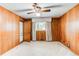 Wood paneled bedroom with ceiling fan, carpet, and a window at 2081 W Ridge Rd, Littleton, CO 80120