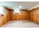 Wood-paneled bedroom with neutral carpet and natural light from window at 2081 W Ridge Rd, Littleton, CO 80120