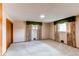 Bright bedroom features neutral carpet, closet, and windows with decorative valances at 2081 W Ridge Rd, Littleton, CO 80120