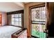A look at the home's entry way, with a security door, a green AstroTurf porch and an adjacent living room at 2081 W Ridge Rd, Littleton, CO 80120
