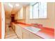 Retro kitchen boasts vintage countertops, ample cabinetry, and a classic sink at 2081 W Ridge Rd, Littleton, CO 80120
