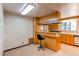 Spacious kitchen featuring a breakfast bar, wood cabinets, and eat-in dining at 2081 W Ridge Rd, Littleton, CO 80120