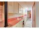 Unique kitchen featuring a brick oven, vintage countertops, and retro cabinetry at 2081 W Ridge Rd, Littleton, CO 80120
