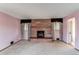 The living room boasts pink walls, a stone fireplace, and windows with patterned curtains for natural light at 2081 W Ridge Rd, Littleton, CO 80120
