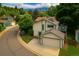 Aerial view of the house with mountain views, a deck, and lush landscaping, perfect for outdoor living at 1080 Tantra Park Cir, Boulder, CO 80305