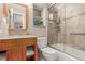Bathroom featuring a glass shower, stone counters and warm wood cabinetry at 1080 Tantra Park Cir, Boulder, CO 80305