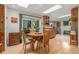 Dining area, with skylights, hardwood floors, adjacent to kitchen, and patio access at 1080 Tantra Park Cir, Boulder, CO 80305