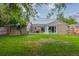Large backyard with a well-kept lawn, patio area and mature trees at 962 Uvalda St, Aurora, CO 80011