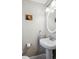 The powder room features a decorative oval mirror and towel rack at 962 Uvalda St, Aurora, CO 80011