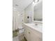 Bright bathroom features a white vanity, shower with white tile and neutral colored walls at 962 Uvalda St, Aurora, CO 80011