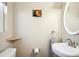 The powder room features a decorative oval mirror and towel rack at 962 Uvalda St, Aurora, CO 80011