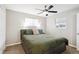 Cozy bedroom featuring a ceiling fan and a comfortable bed with a green comforter at 962 Uvalda St, Aurora, CO 80011