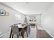 Bright dining room with wood floors, neutral paint and large windows at 962 Uvalda St, Aurora, CO 80011
