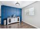 Dining area with wainscoting accent wall, wood floors, and a stylish console at 962 Uvalda St, Aurora, CO 80011