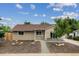 Inviting tan single-story home featuring manicured front yard with rock and mulch accents at 962 Uvalda St, Aurora, CO 80011