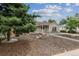 Attractive single-story home with tan exterior, manicured lawn, walkway, and mature trees at 962 Uvalda St, Aurora, CO 80011