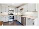 Modern kitchen featuring stainless steel appliances, granite countertops, and sleek cabinets at 962 Uvalda St, Aurora, CO 80011