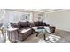 Spacious living room with a comfortable sectional sofa and modern glass coffee table at 962 Uvalda St, Aurora, CO 80011