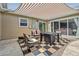 Inviting outdoor patio area with comfortable seating, a checker rug and awning at 962 Uvalda St, Aurora, CO 80011