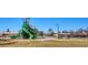 Colorful playground with a large green slide, climbing structures, and a picnic shelter at 962 Uvalda St, Aurora, CO 80011