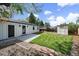 This backyard features a well-manicured lawn, a storage shed, a patio, and lush landscaping at 1360 S Forest Way, Denver, CO 80222