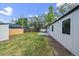 This backyard features a well-manicured lawn, a small patio, and mature trees at 1360 S Forest Way, Denver, CO 80222