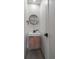 Modern half bath with floating vanity and stylish round mirror at 1360 S Forest Way, Denver, CO 80222