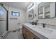 Modern bathroom featuring a double vanity, sleek fixtures, and a glass-enclosed shower at 1360 S Forest Way, Denver, CO 80222