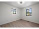 A bright bedroom with wood floors, two windows, and neutral walls at 1360 S Forest Way, Denver, CO 80222