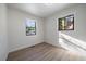 Bright bedroom with hardwood floors and natural light streaming in from two windows at 1360 S Forest Way, Denver, CO 80222