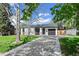 Charming single-story home with a well-maintained front yard and a private driveway to a one car garage at 1360 S Forest Way, Denver, CO 80222
