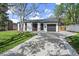 Charming single-story home with a well-maintained front yard and a private driveway to a one car garage at 1360 S Forest Way, Denver, CO 80222