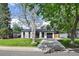 Charming single-story home with a well-maintained front yard and a private driveway to a one car garage at 1360 S Forest Way, Denver, CO 80222