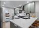 Modern kitchen with sleek cabinets, stainless steel appliances, and a stylish quartz countertop with bar stool seating at 1360 S Forest Way, Denver, CO 80222