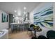 Modern kitchenette featuring gray cabinetry, marble countertops, and seamless open plan to the living space at 1360 S Forest Way, Denver, CO 80222