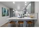 Modern kitchenette featuring gray cabinetry, marble countertops, and seamless open plan to the living space at 1360 S Forest Way, Denver, CO 80222