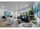 Inviting living room with a large window, plants, and modern decor offering a comfortable, relaxing ambiance at 1360 S Forest Way, Denver, CO 80222