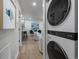 Open concept living area with view of modern kitchen, dining space and in-unit laundry at 1360 S Forest Way, Denver, CO 80222