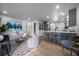 Bright, airy living space with wood floors, gray accents, and a stylish kitchen featuring counter seating at 1360 S Forest Way, Denver, CO 80222
